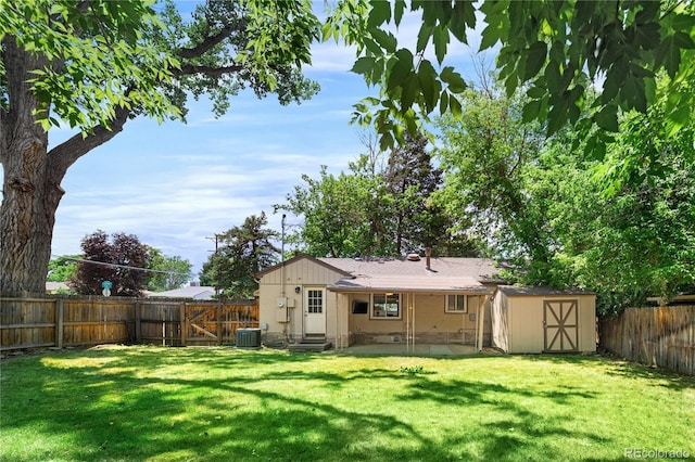 2680 S Garfield Cir, Denver, CO 80210 - rear view of house featuring entry steps, a fenced backyard, a storage unit, and a patio