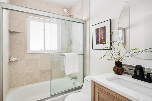 2680 S Garfield Cir, Denver, CO 80210 - bathroom featuring vanity and combined bath / shower with glass door