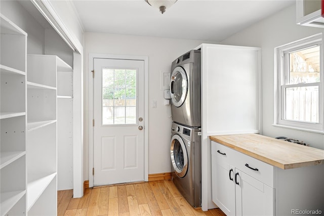 2680 S Garfield Cir, Denver, CO 80210 - laundry area featuring stacked washer and clothes dryer and light wood-type flooring