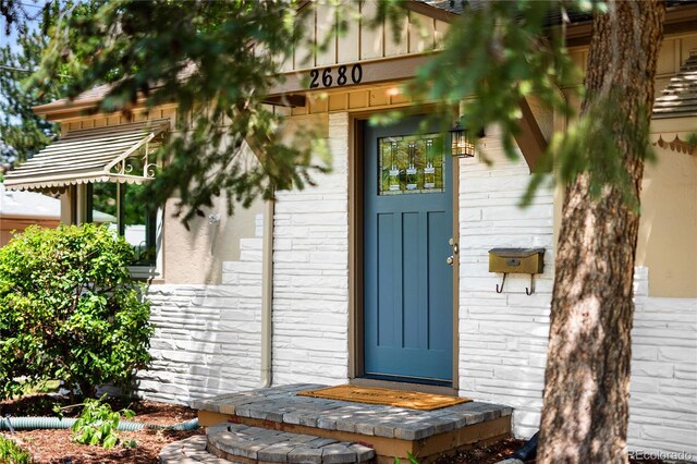 2680 S Garfield Cir, Denver, CO 80210 - doorway to property featuring stone siding