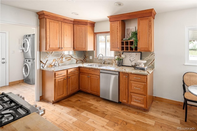 2680 S Garfield Cir, Denver, CO 80210 - kitchen with appliances with stainless steel finishes, estacked washer and dryer, light wood finished floors, tasteful backsplash, and recessed lighting