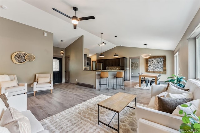 143 Brady Rd, Buena Vista, CO 81211 - living area with vaulted ceiling, light wood-type flooring, ceiling fan, and baseboards