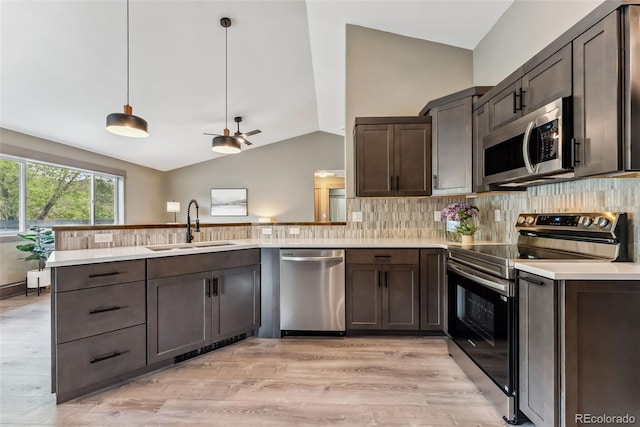 143 Brady Rd, Buena Vista, CO 81211 - kitchen with appliances with stainless steel finishes, a sink, vaulted ceiling, dark brown cabinetry, and a peninsula