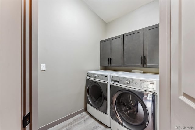 143 Brady Rd, Buena Vista, CO 81211 - laundry room with cabinet space, washer and clothes dryer, light wood-style flooring, and baseboards