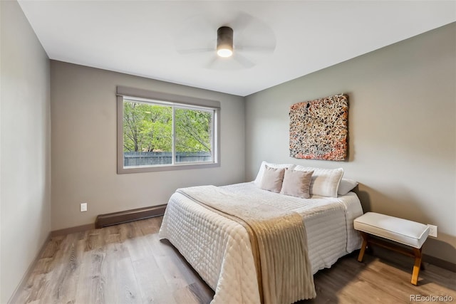 143 Brady Rd, Buena Vista, CO 81211 - bedroom with baseboard heating, wood finished floors, baseboards, and ceiling fan