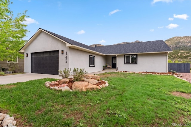 143 Brady Rd, Buena Vista, CO 81211 - ranch-style house with an attached garage, concrete driveway, stucco siding, and roof with shingles