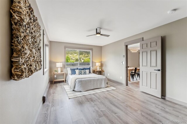 143 Brady Rd, Buena Vista, CO 81211 - bedroom featuring light wood-style floors, a baseboard heating unit, and ceiling fan