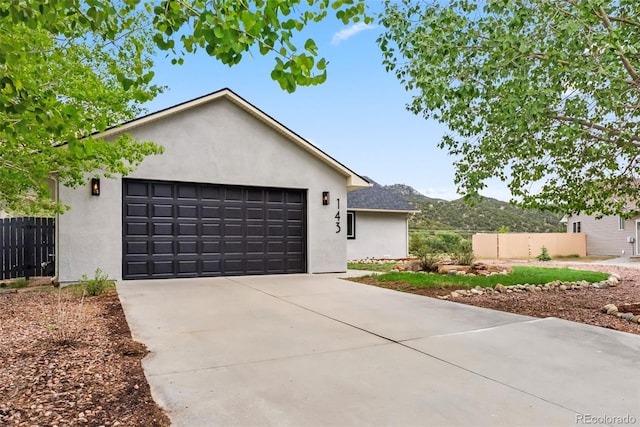 143 Brady Rd, Buena Vista, CO 81211 - single story home with stucco siding, concrete driveway, and a garage