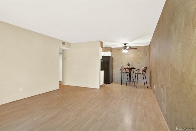7755 E Quincy Ave Unit 206, Denver, CO 80237 - unfurnished living room featuring a ceiling fan and light wood-style floors