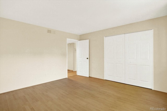 7755 E Quincy Ave Unit 206, Denver, CO 80237 - unfurnished bedroom featuring light wood-style flooring and a closet
