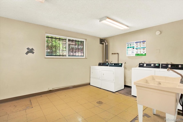 7755 E Quincy Ave Unit 206, Denver, CO 80237 - community laundry room featuring washing machine and dryer and a textured ceiling