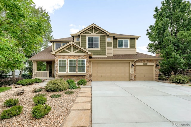 craftsman house featuring stone siding, a garage, concrete driveway, covered porch, and a shingled roof