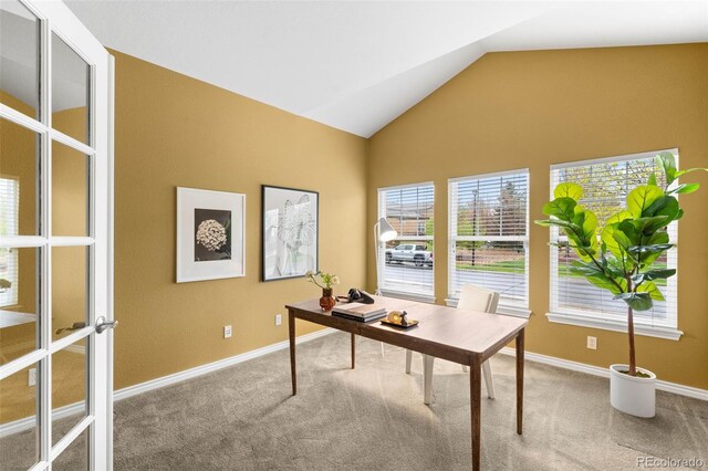 office area with carpet, vaulted ceiling, and baseboards
