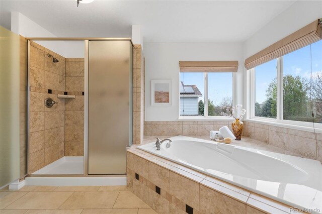 full bathroom with a stall shower, tile patterned flooring, and a bath