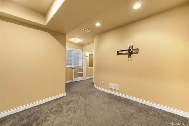 spare room featuring carpet flooring, baseboards, and recessed lighting