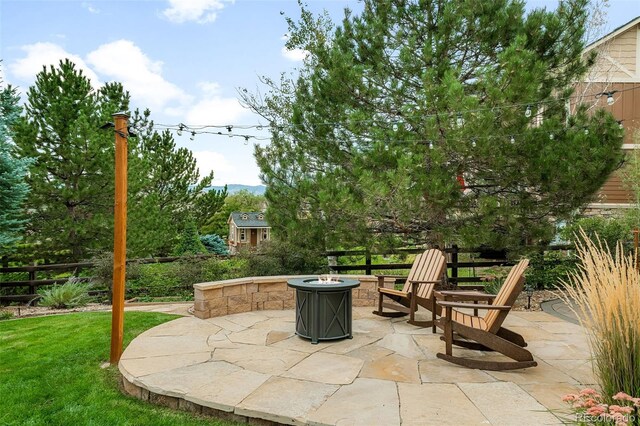 view of patio / terrace featuring a fire pit and fence