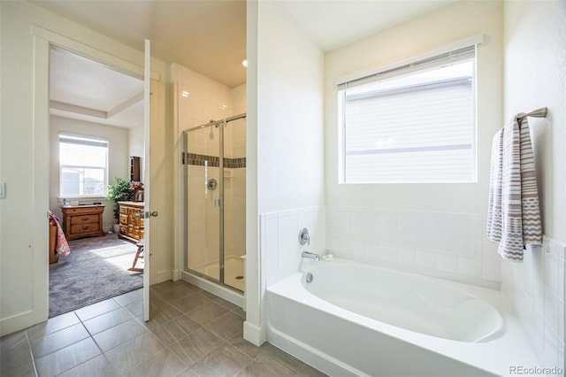 bathroom featuring tile patterned flooring and shower with separate bathtub