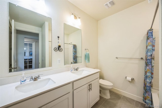 bathroom with tile patterned flooring, vanity, and toilet