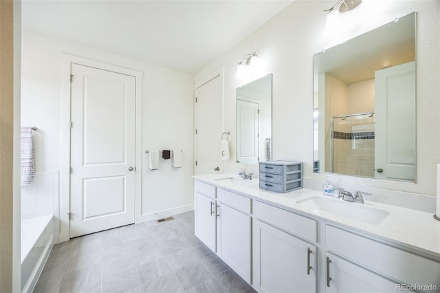 bathroom with vanity and independent shower and bath