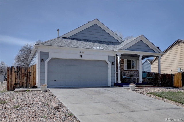 4361 Kirk Ct, Denver, CO 80249 - ranch-style home featuring concrete driveway, a shingled roof, an attached garage, fence, and a porch