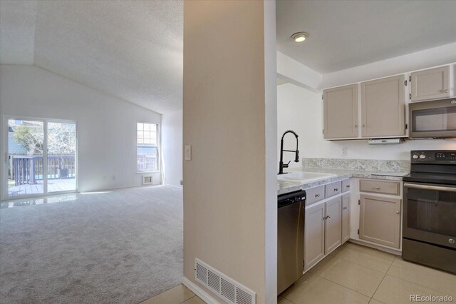 4361 Kirk Ct, Denver, CO 80249 - kitchen with a sink, vaulted ceiling, visible vents, light countertops, and appliances with stainless steel finishes