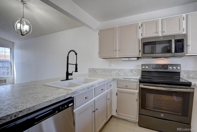 4361 Kirk Ct, Denver, CO 80249 - kitchen with stainless steel appliances, light countertops, a sink, light tile patterned flooring, and decorative light fixtures