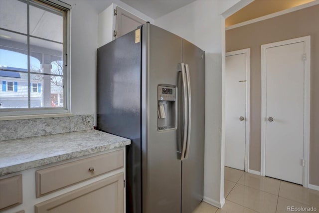 4361 Kirk Ct, Denver, CO 80249 - kitchen with baseboards, stainless steel refrigerator with ice dispenser, light tile patterned flooring, and light countertops
