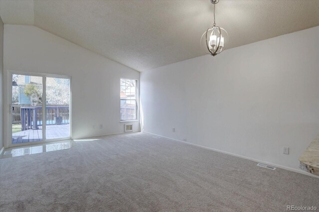 4361 Kirk Ct, Denver, CO 80249 - empty room with vaulted ceiling, carpet floors, an inviting chandelier, baseboards, and visible vents