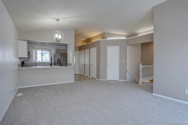 4361 Kirk Ct, Denver, CO 80249 - unfurnished living room featuring light carpet, lofted ceiling, and baseboards