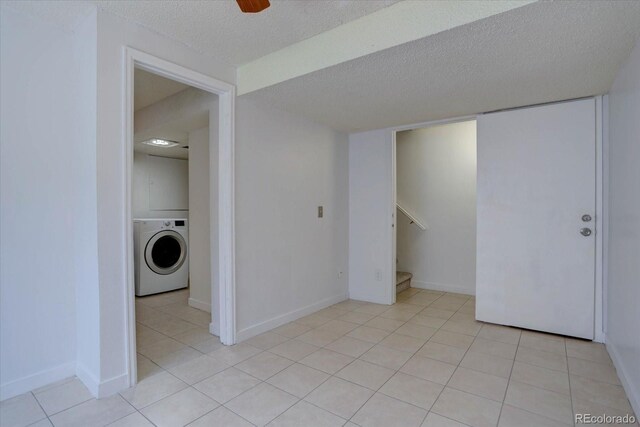 4361 Kirk Ct, Denver, CO 80249 - spare room featuring stairway, a ceiling fan, light tile patterned floors, a textured ceiling, and washer / clothes dryer