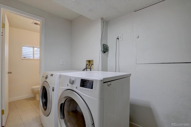 4361 Kirk Ct, Denver, CO 80249 - washroom with light tile patterned flooring, baseboards, visible vents, separate washer and dryer, and laundry area