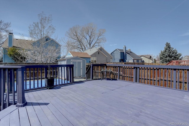 4361 Kirk Ct, Denver, CO 80249 - deck with a residential view, an outbuilding, a shed, and fence