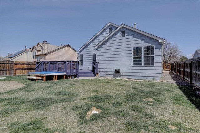 4361 Kirk Ct, Denver, CO 80249 - rear view of house featuring a fenced backyard, a yard, and a deck