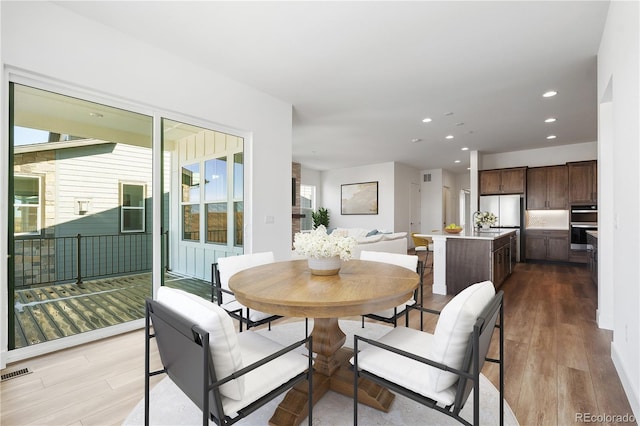 dining area with visible vents, wood finished floors, and recessed lighting