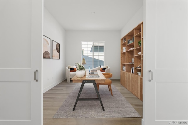 office with light wood-style floors and baseboards