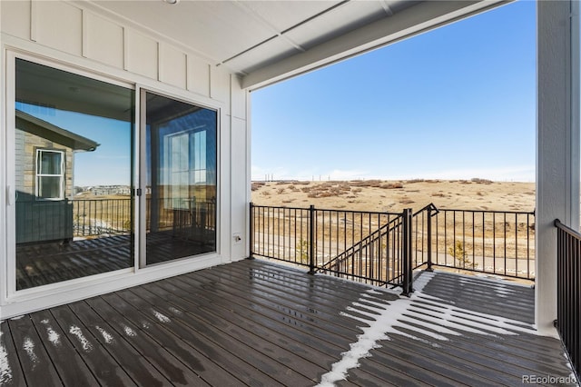 wooden terrace featuring a rural view