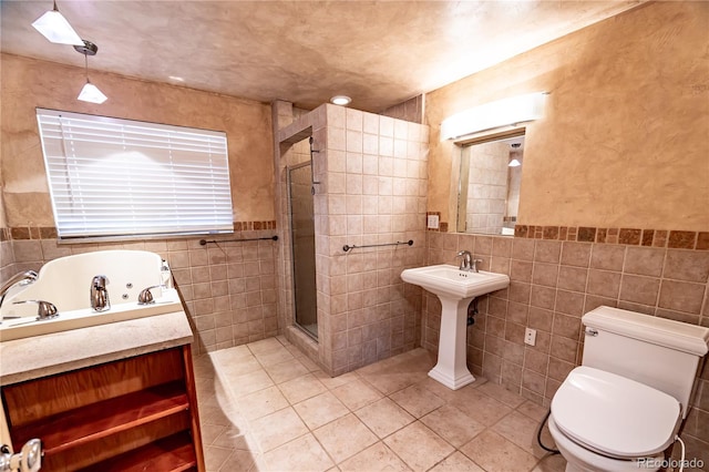 bathroom with tile walls, toilet, independent shower and bath, and tile patterned floors