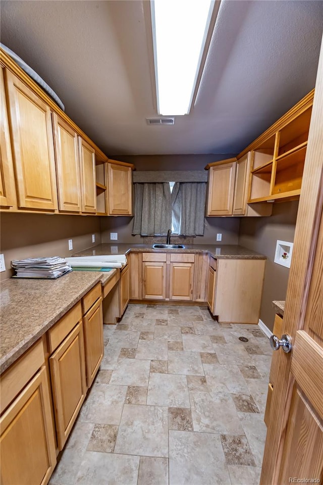 kitchen with light stone counters and sink