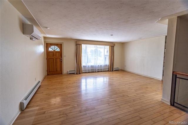 unfurnished living room featuring a wall unit AC, baseboard heating, and light hardwood / wood-style flooring