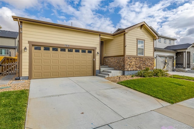 view of front of property with a front yard and a garage