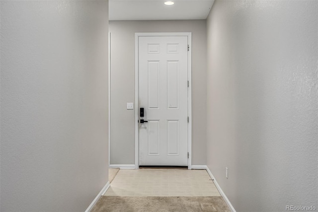 entryway with light colored carpet