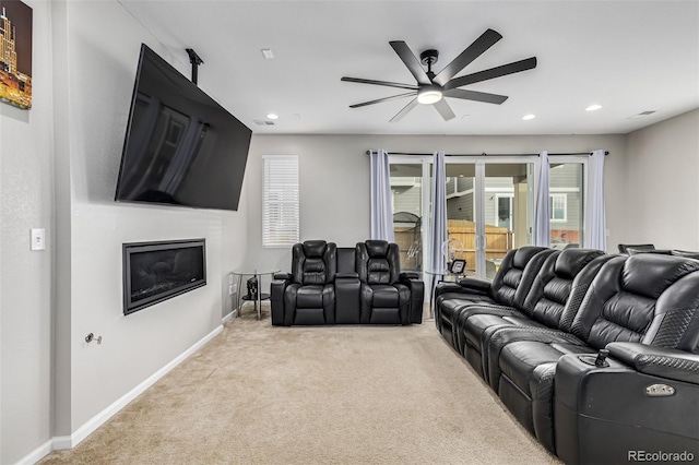 carpeted home theater room featuring ceiling fan