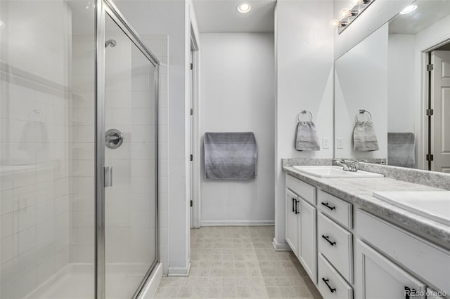 bathroom with vanity and a shower with shower door