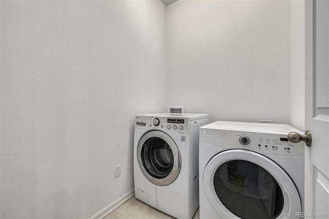 clothes washing area with washing machine and dryer