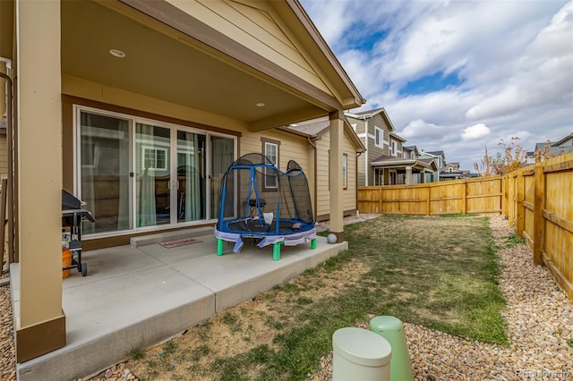 view of yard with a patio and a trampoline