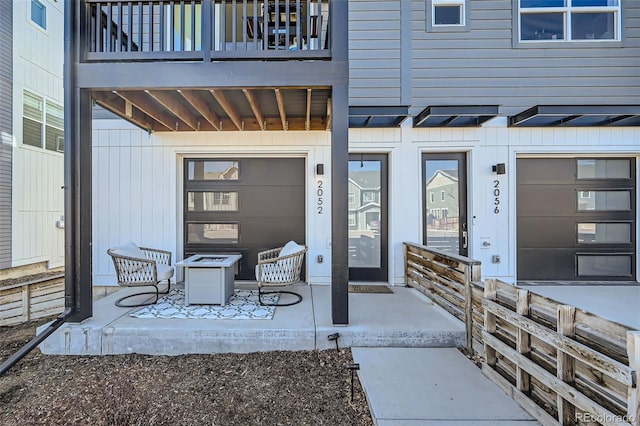 entrance to property with a garage and a balcony