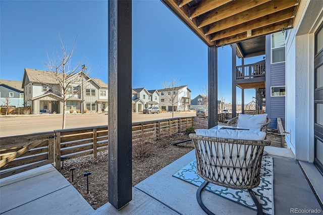 view of patio with a residential view and fence