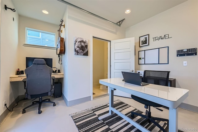 office area with concrete flooring, recessed lighting, and baseboards