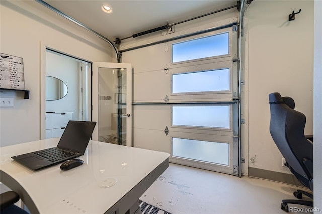 office area with a garage, recessed lighting, and concrete floors