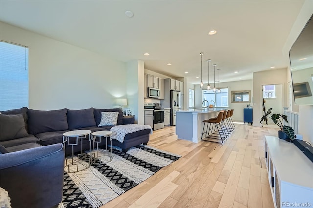 living room featuring light wood finished floors and recessed lighting